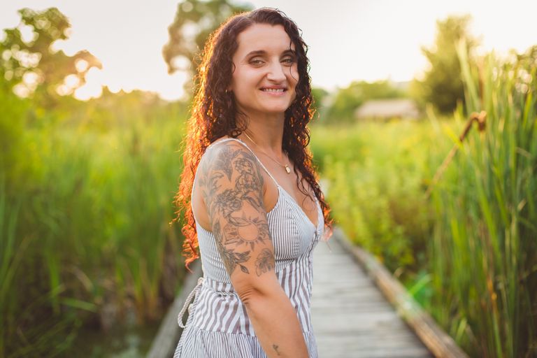 Irina standing in a sunlit garden